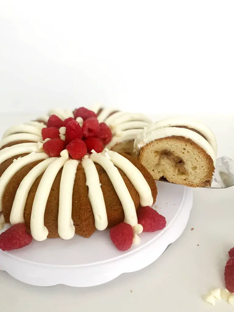 serving a slice of gluten-free white chocolate raspberry Bundt cake 